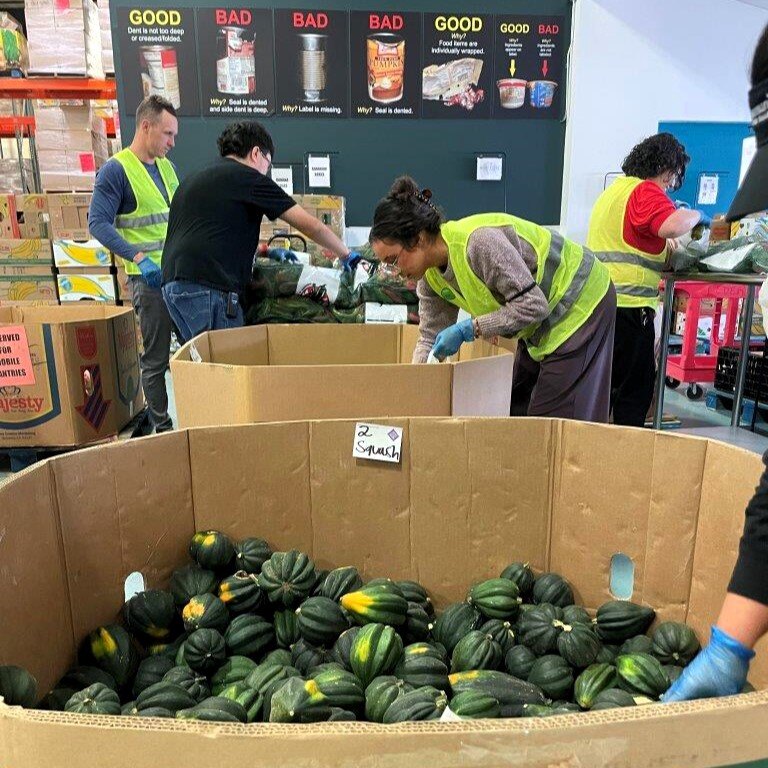 Flatirons Bank volunteers packing produce in bags